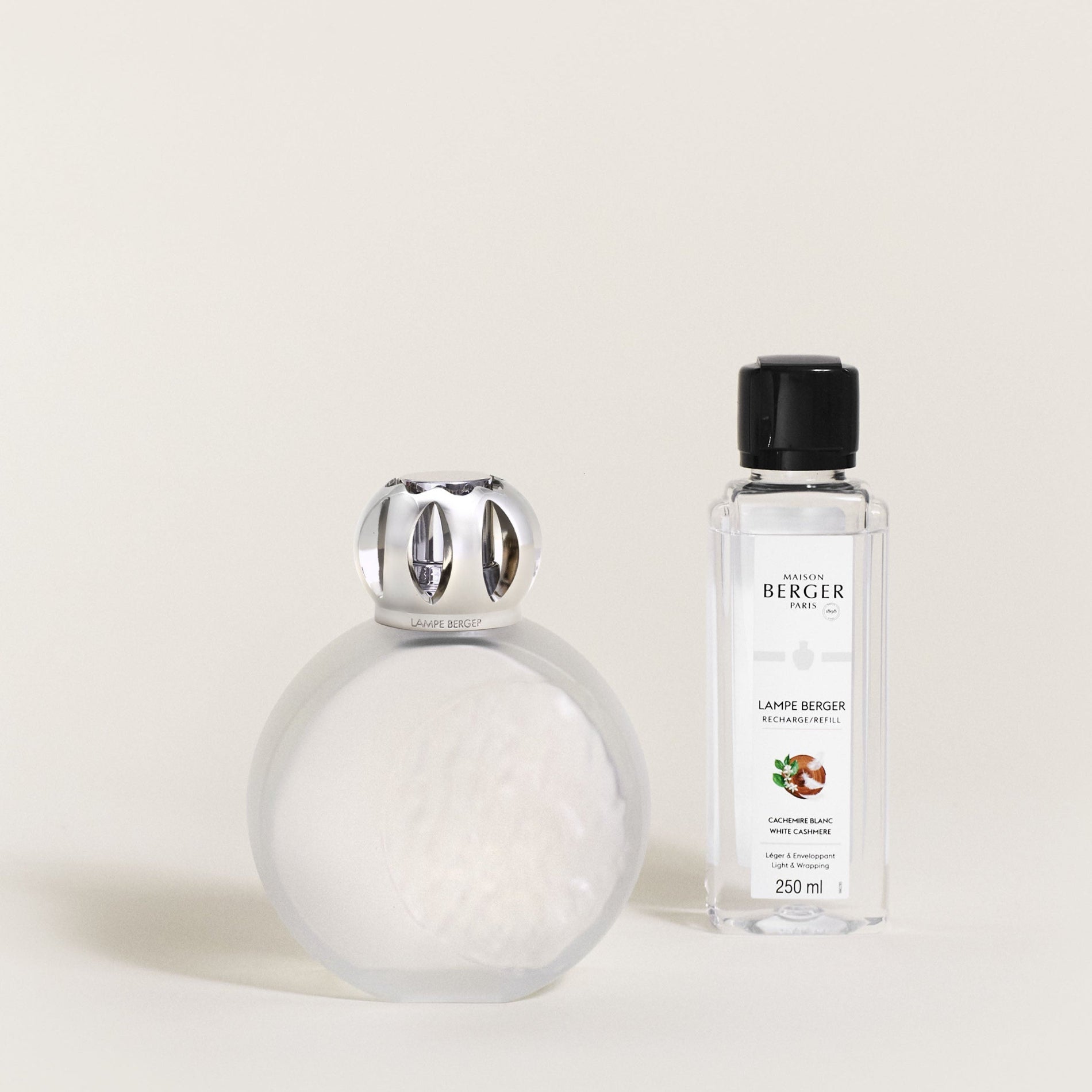 White diffuser and bottle with black cap on a light beige background