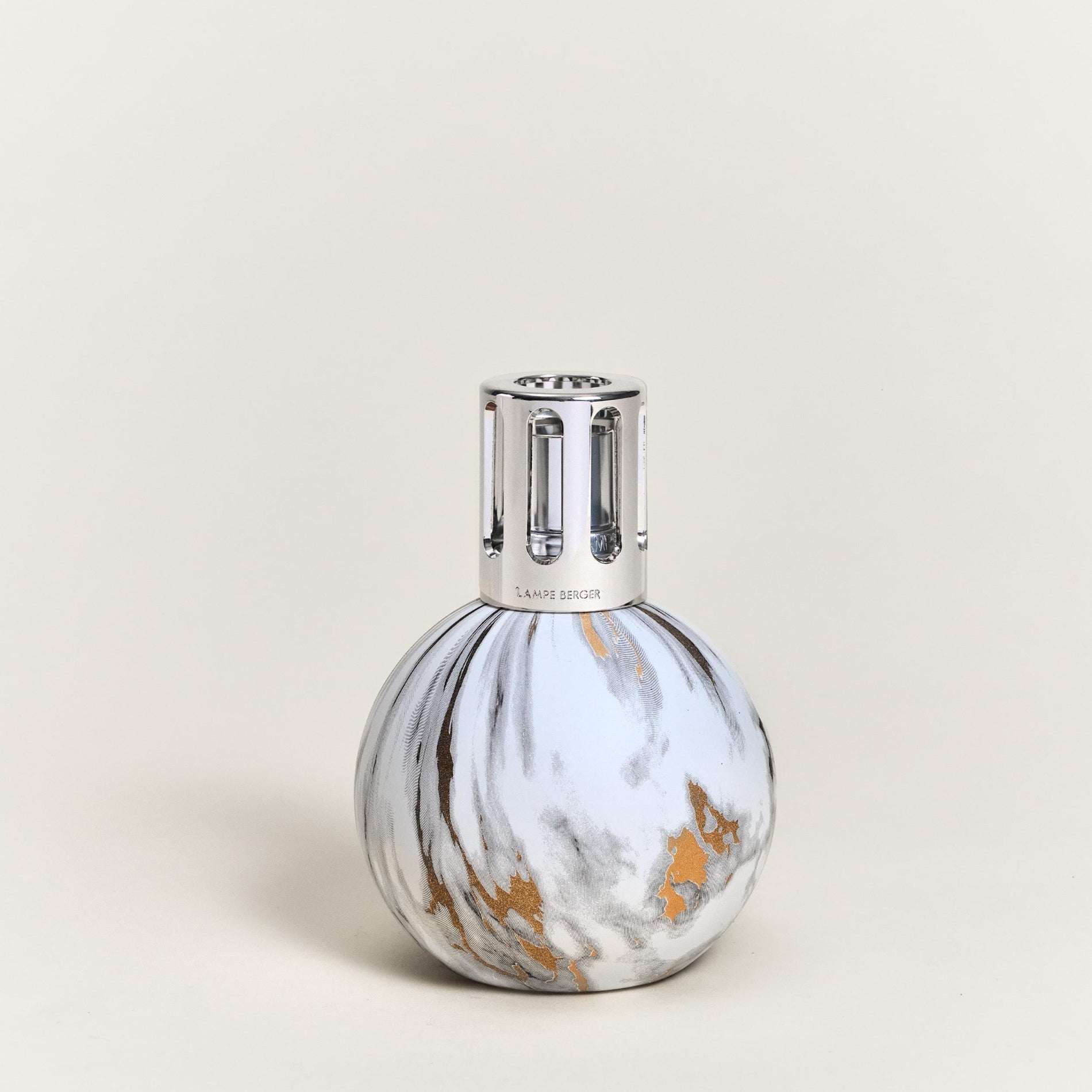 Marble-patterned bottle with silver cap on a beige background