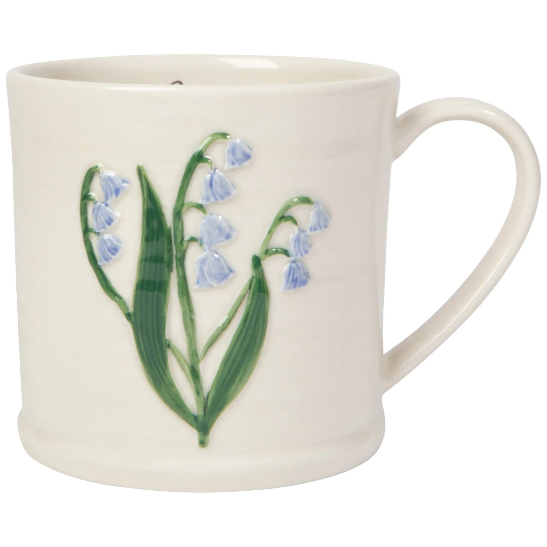 White mug with floral design on a white background
