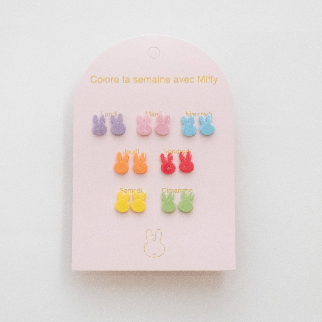 Set of colorful bunny-shaped earrings on a pink card with text