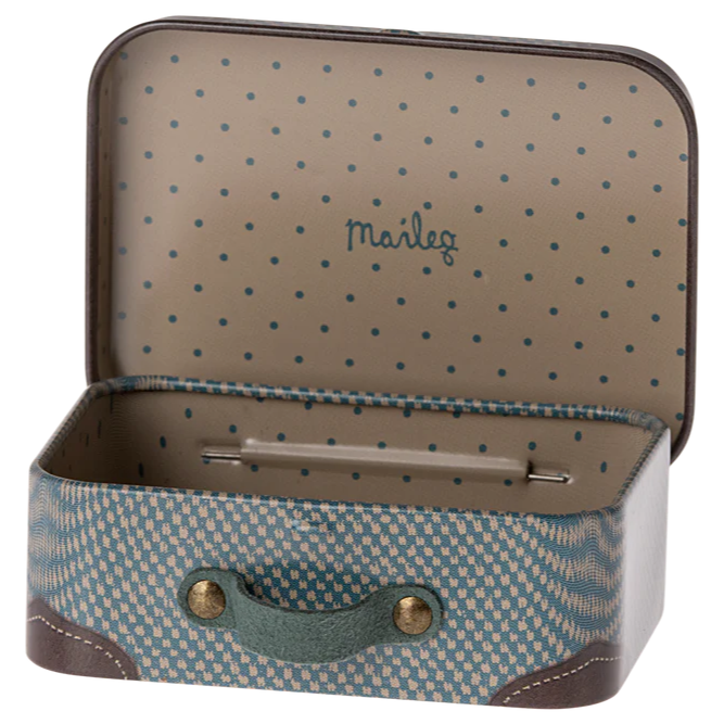 A small blue and white polka-dotted metal suitcase with the brand name 'Maileg' visible inside.