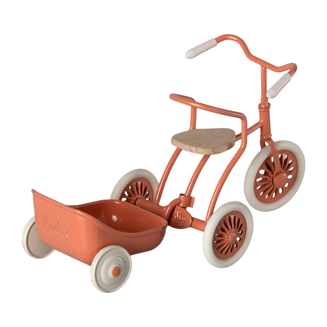 Vintage-style toy tricycle with a small seat and wheels on a white background