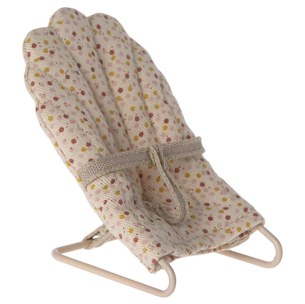 A beige baby sitter accessory for toy rabbits and baby mice, covered in fabric with a polka dot pattern.