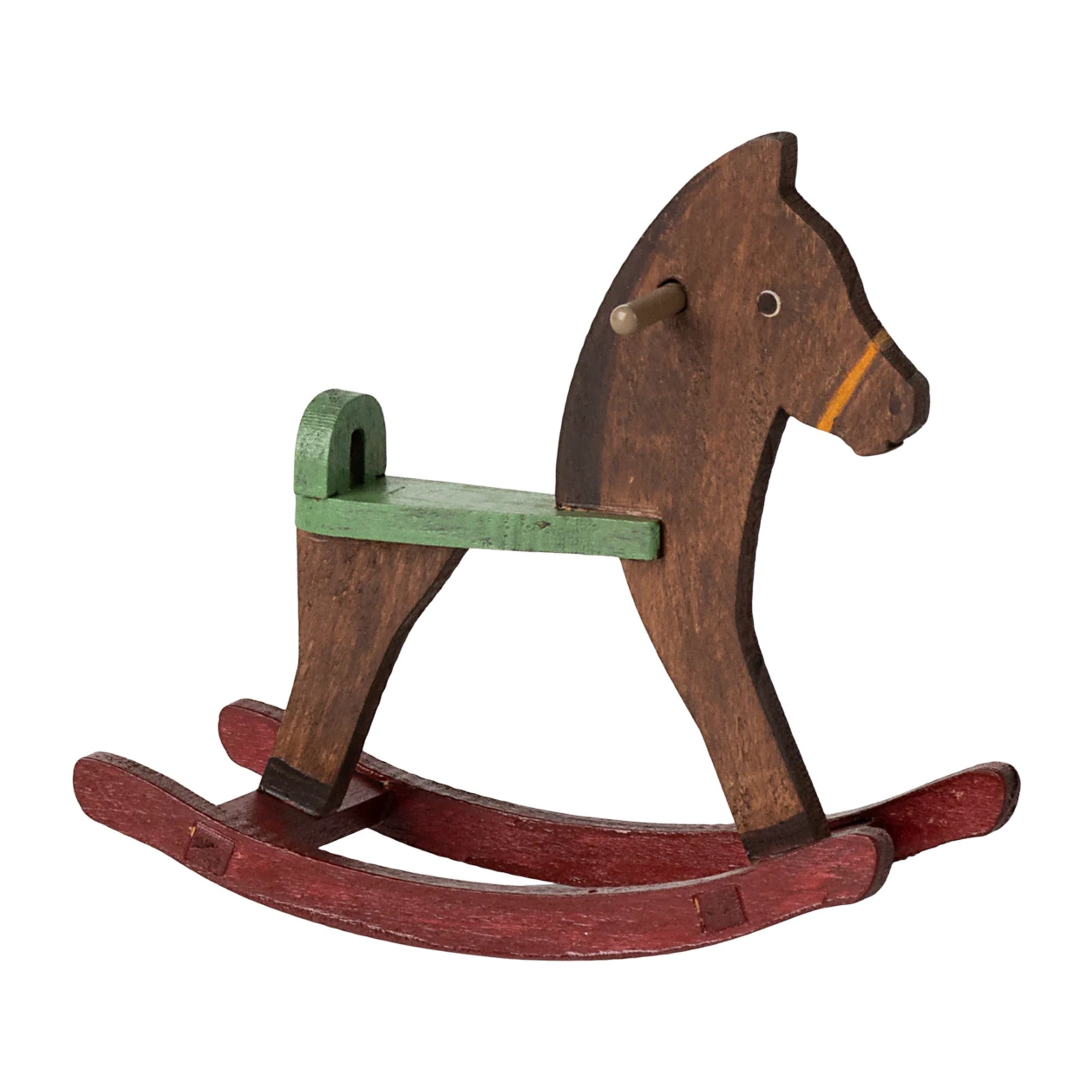 Wooden rocking horse with a green seat on a white background