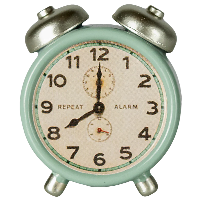 Vintage-style alarm clock with a light green casing on a white background