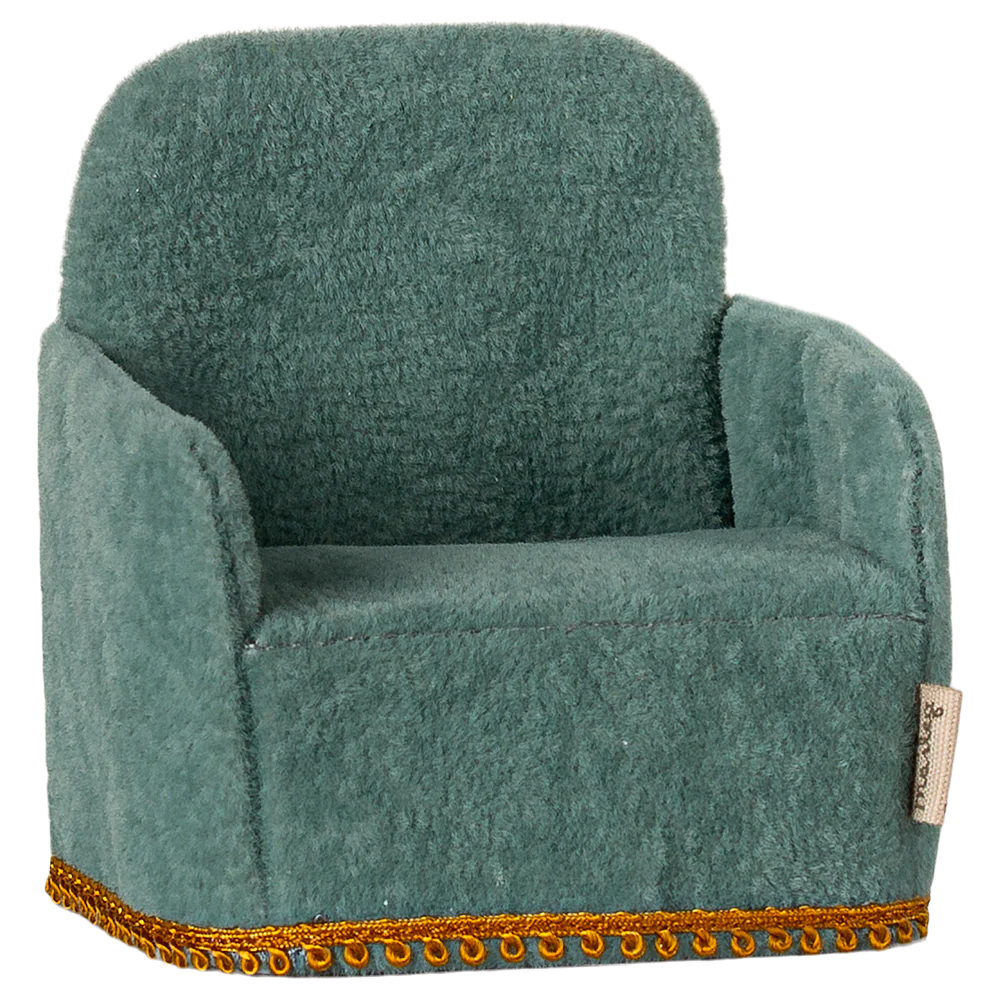 A green folding chair toy designed for small children, with a plush texture and decorative trim around the seat.