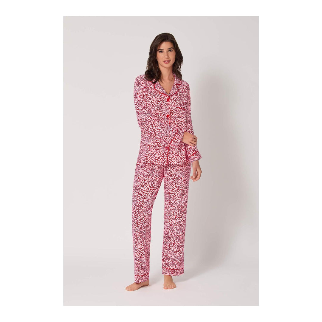 Woman wearing a red and white patterned pajama set on a white background