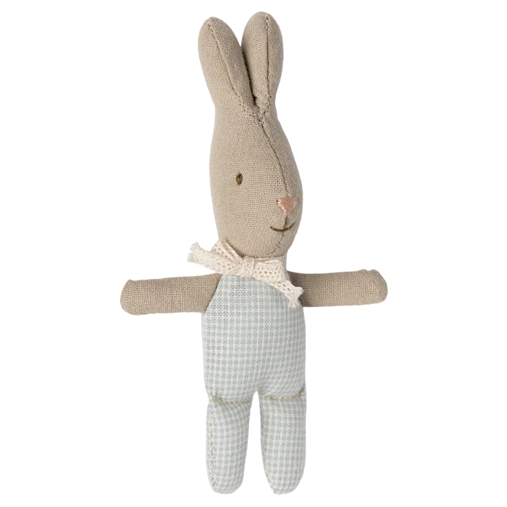 A small toy rabbit with a blue checkered outfit and a bow around its neck.