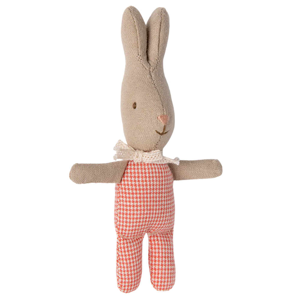 A small plush toy rabbit with a red checkered outfit.