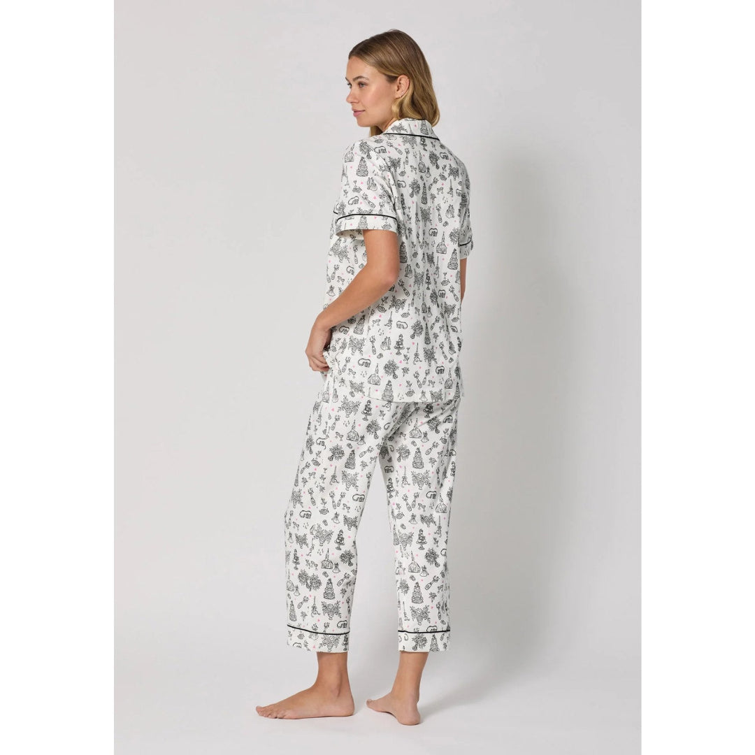 Woman wearing a patterned pajama set on a plain background