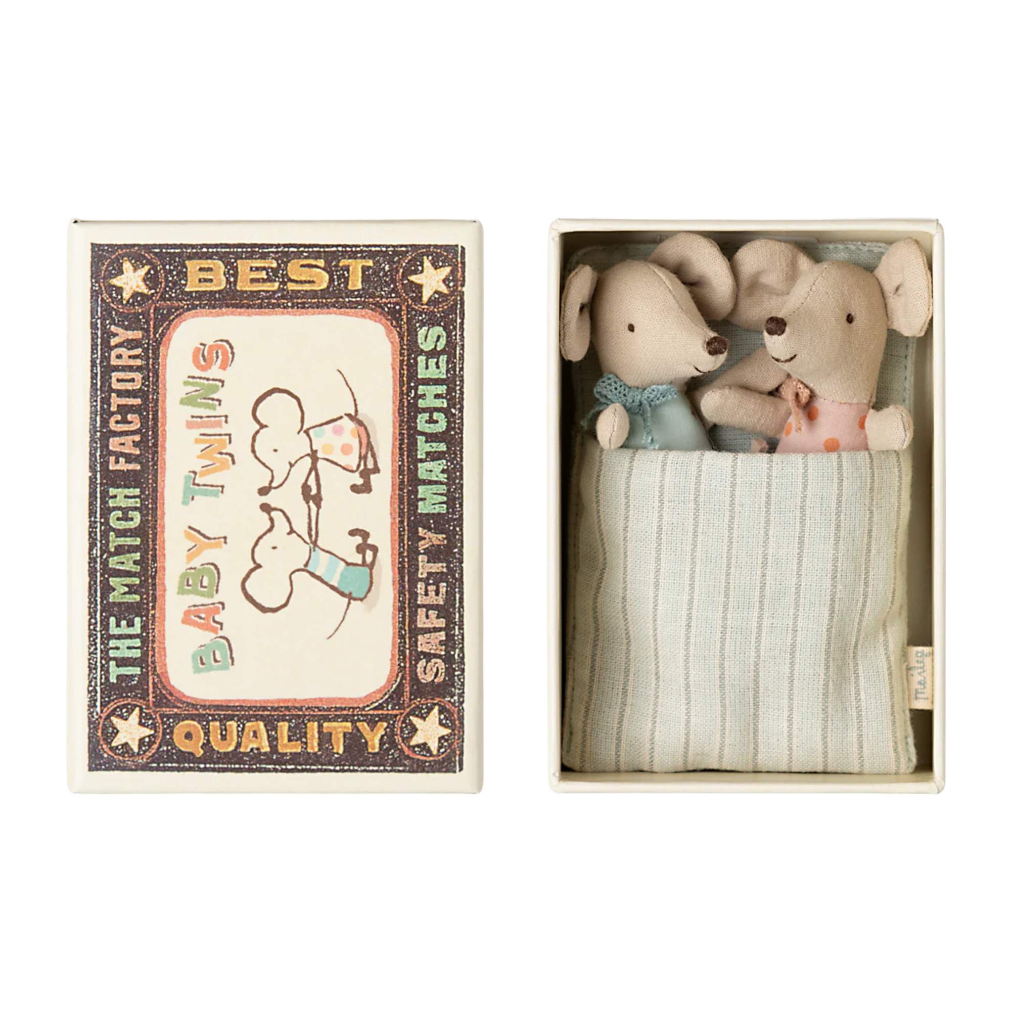 Two small stuffed animals in a matchbox labeled 'Best Match Factory'.