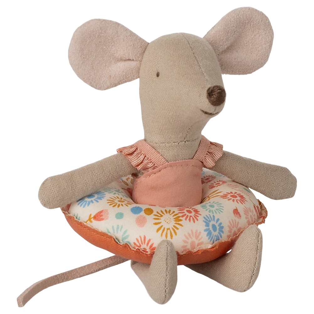 Stuffed mouse toy with a floral cushion on a white background