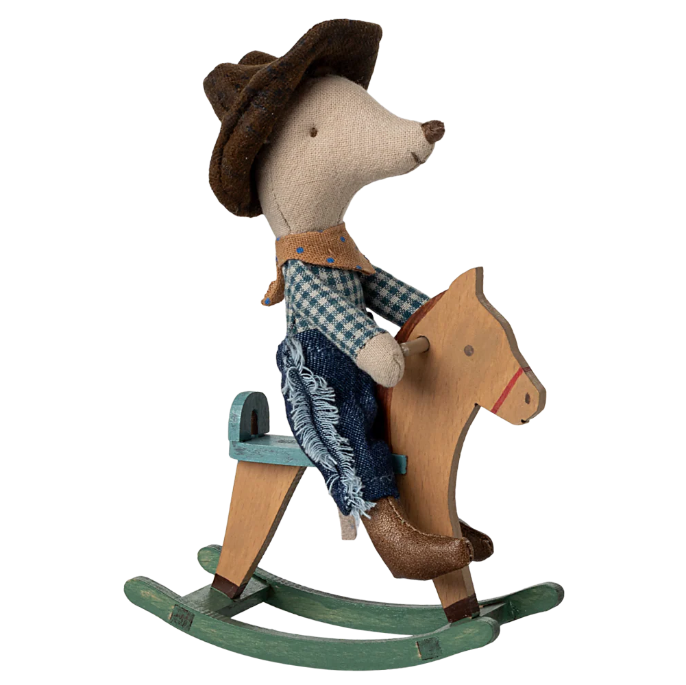 Toy mouse in cowboy outfit riding a wooden horse on a white background