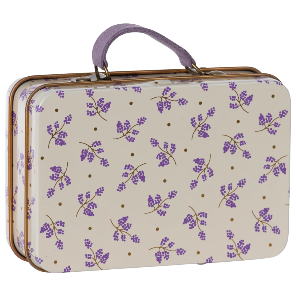 Vintage-style suitcase with purple floral pattern on beige background