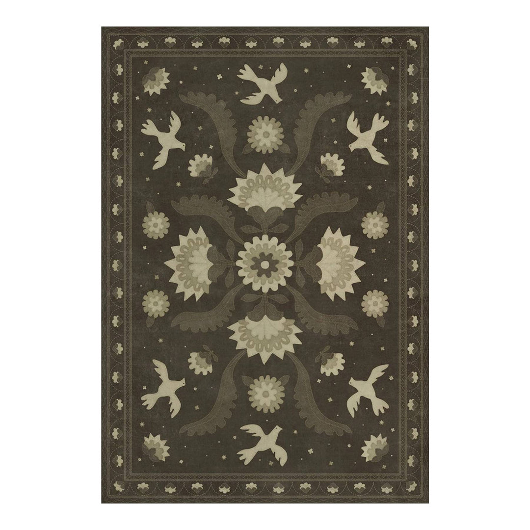 Decorative rug with floral and bird pattern on a dark background