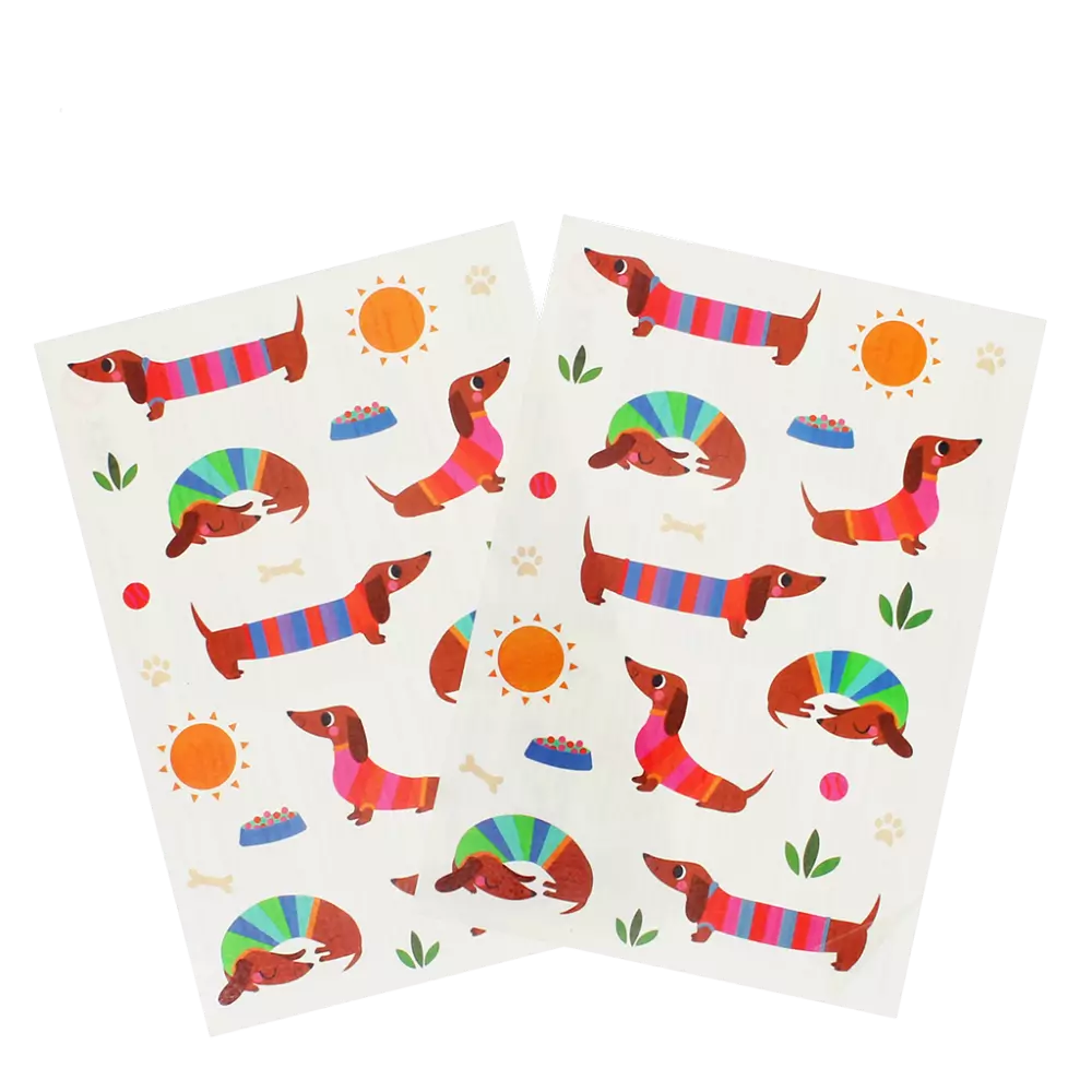 Two sheets of paper with colorful dachshund illustrations on a white background