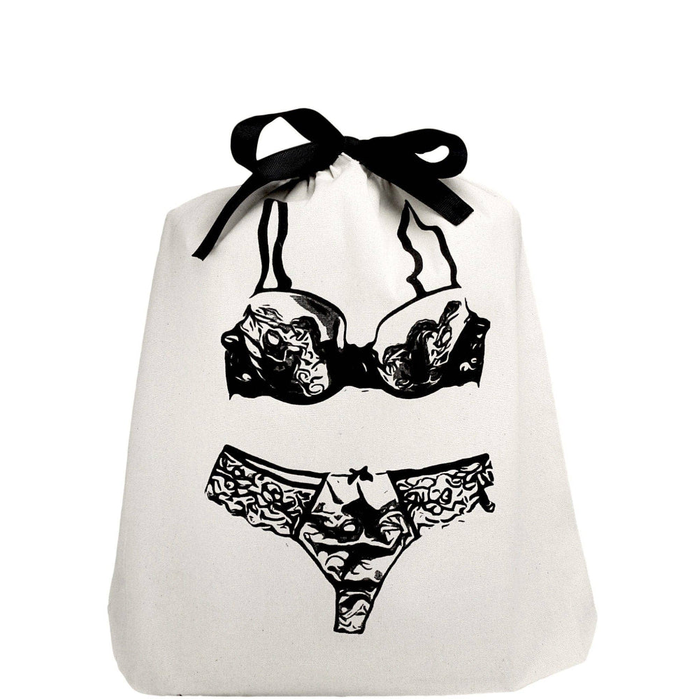A white lace lingerie travel bag with a black bow and design details, lying flat.