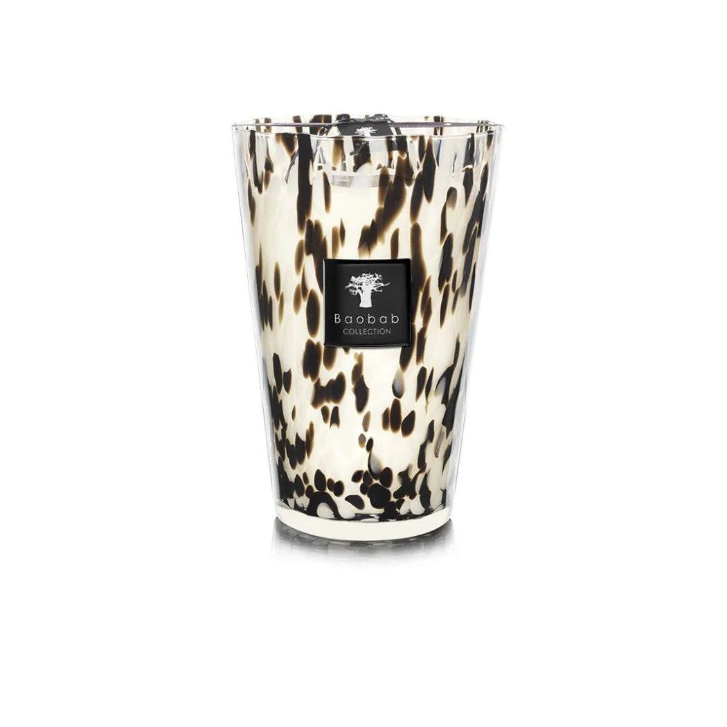A collection of Baobab Black Pearls scented candles in various sizes, featuring a black and white patterned design, placed in transparent glass holders.