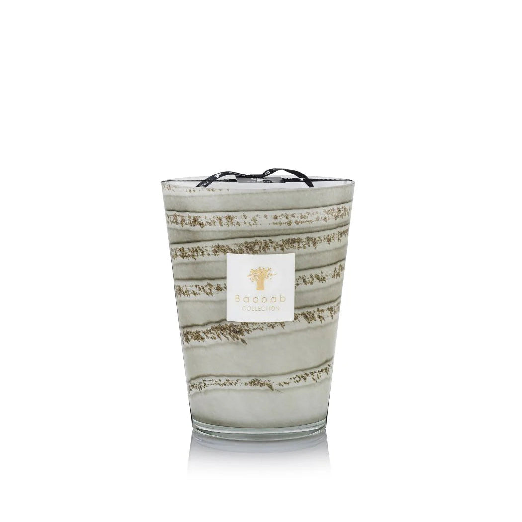 A set of hand-blown gray glass candles with various sizes, each holding a candle with a beige label.