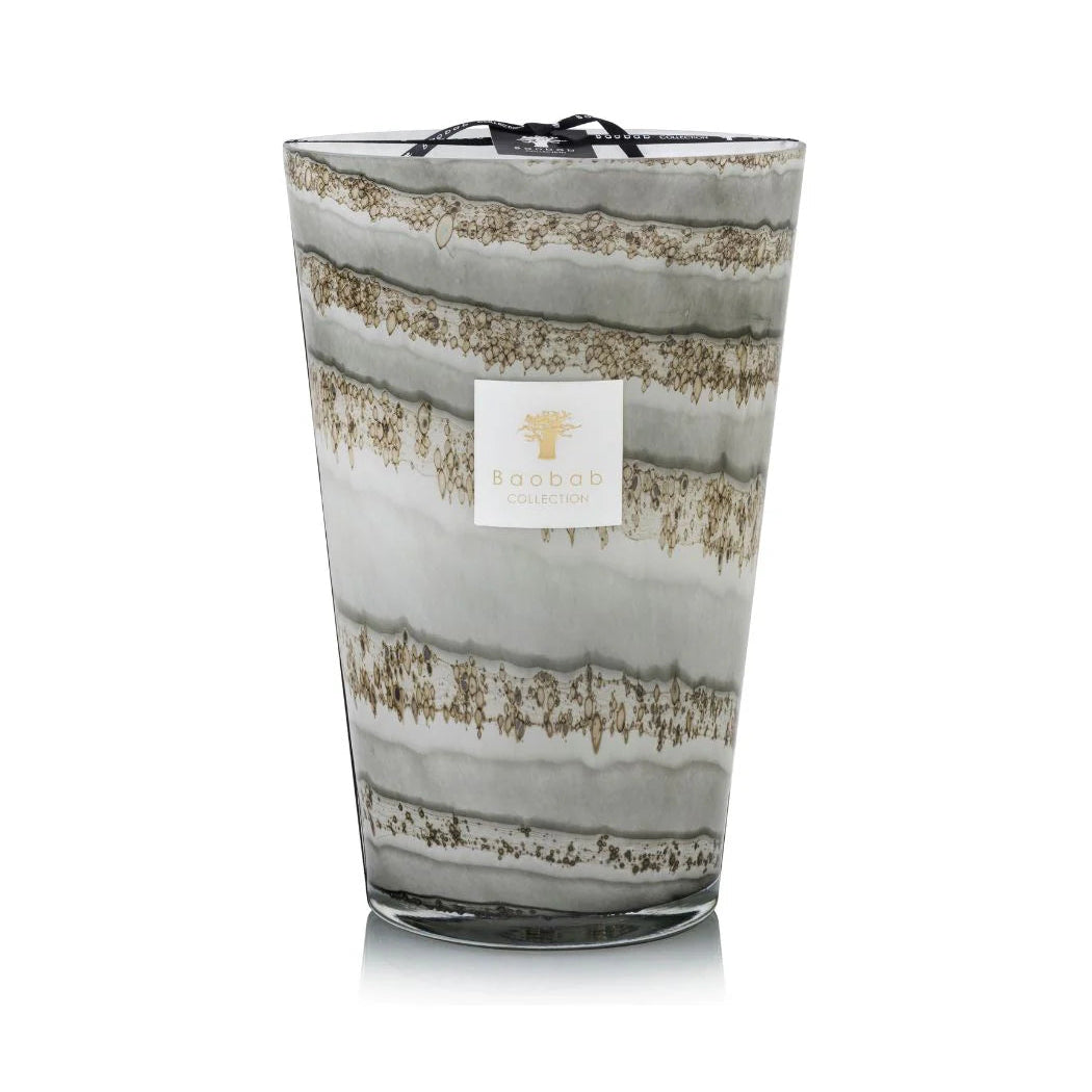 A set of hand-blown gray glass candles with various sizes, each holding a candle with a beige label.