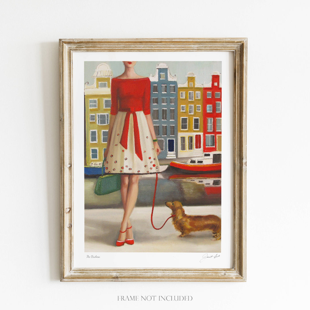 Framed artwork of a woman in a red coat with a dog, set against a cityscape.