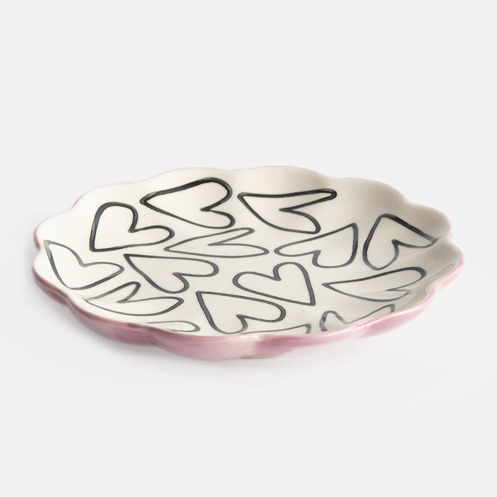 Decorative plate with a black heart pattern on a white background