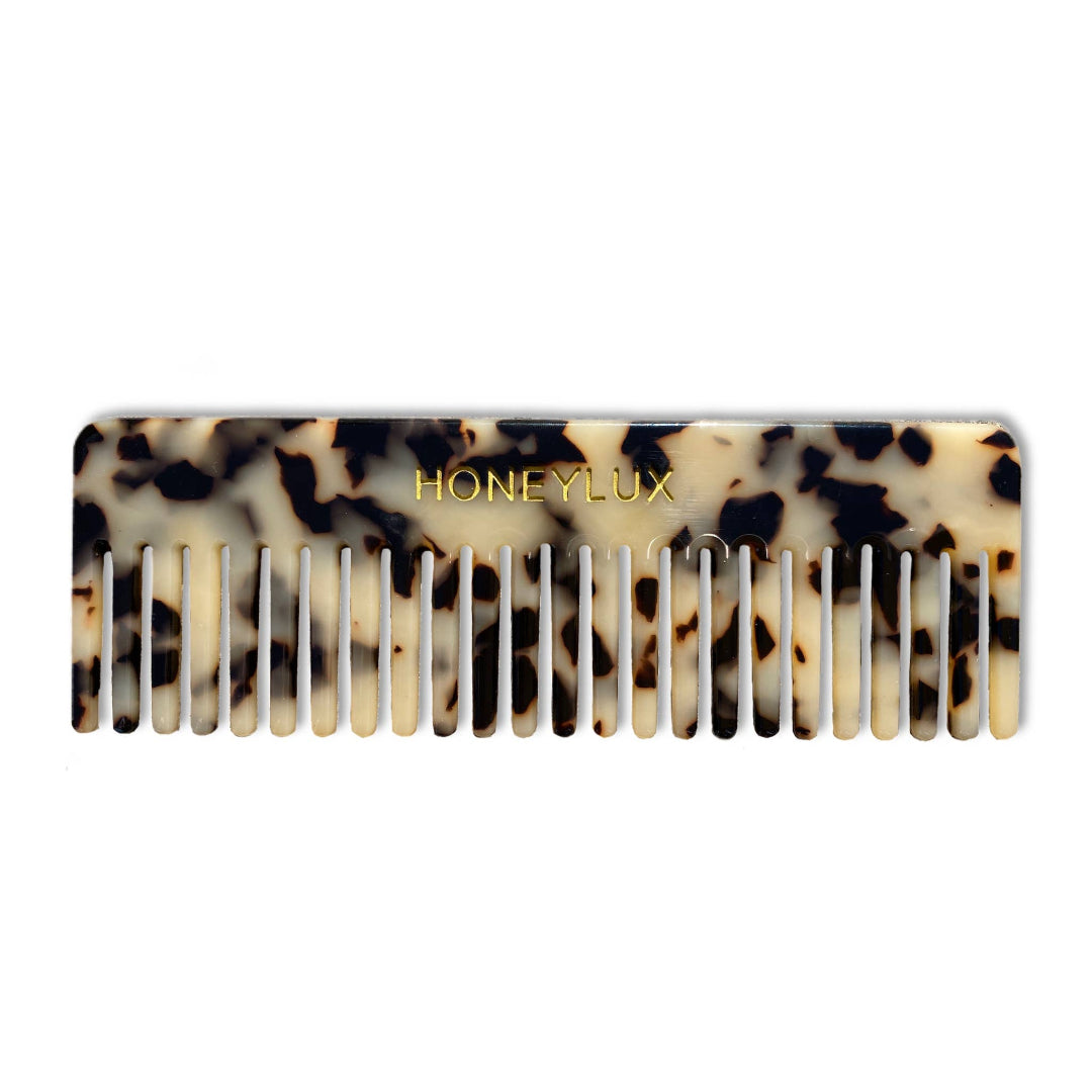 Tortoise patterned comb with 'Honeylux' branding on a white background.