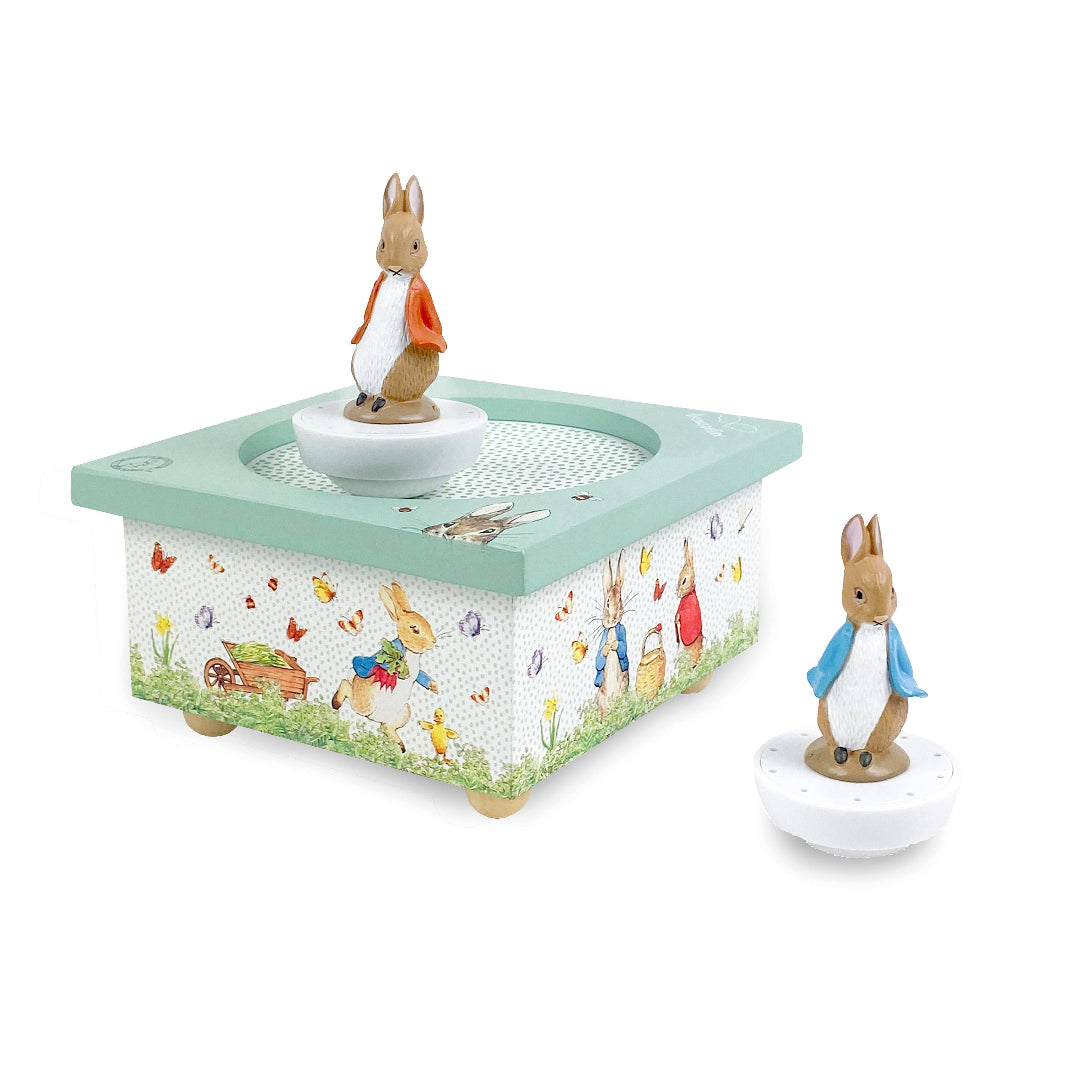 Music box with Peter Rabbit figures on a white background
