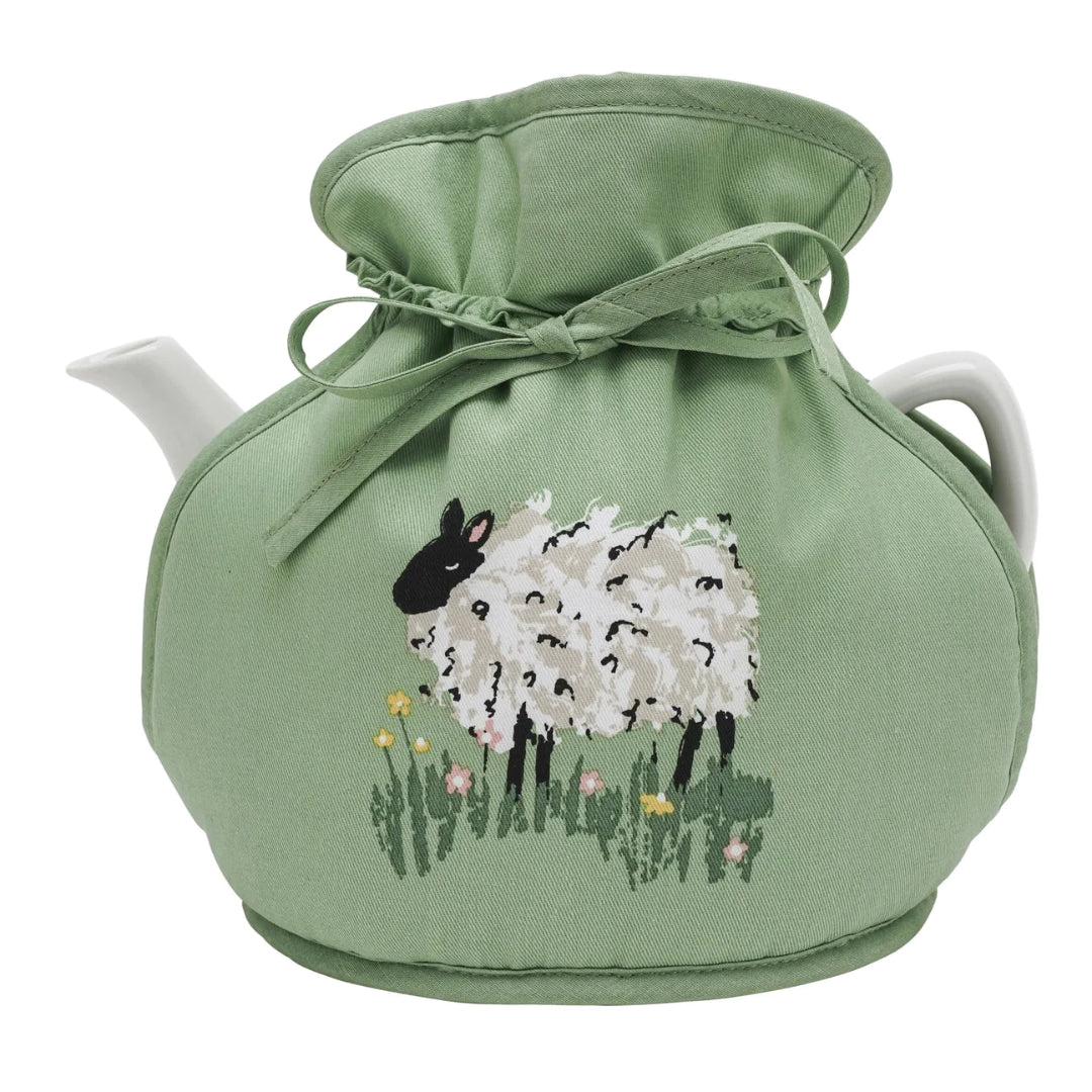 A green tea cosy with an illustration of a sheepin bright meadow flowers.