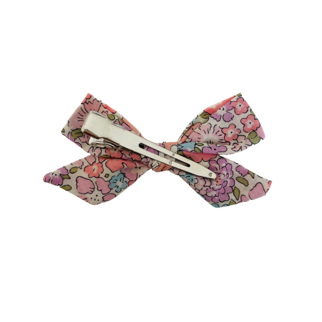 Floral-patterned bow hair clip on a white background