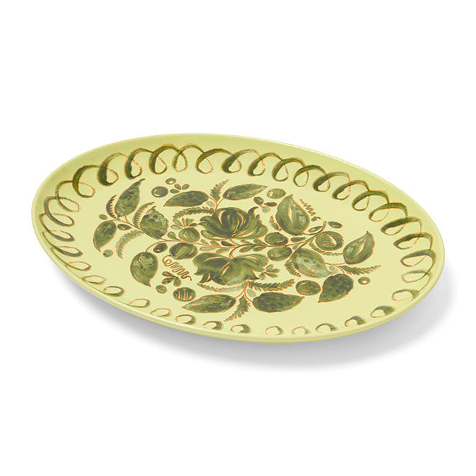 Decorative plate with green leaf pattern on a white background