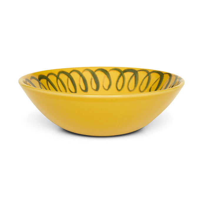 Yellow ceramic bowl with green design on a white background
