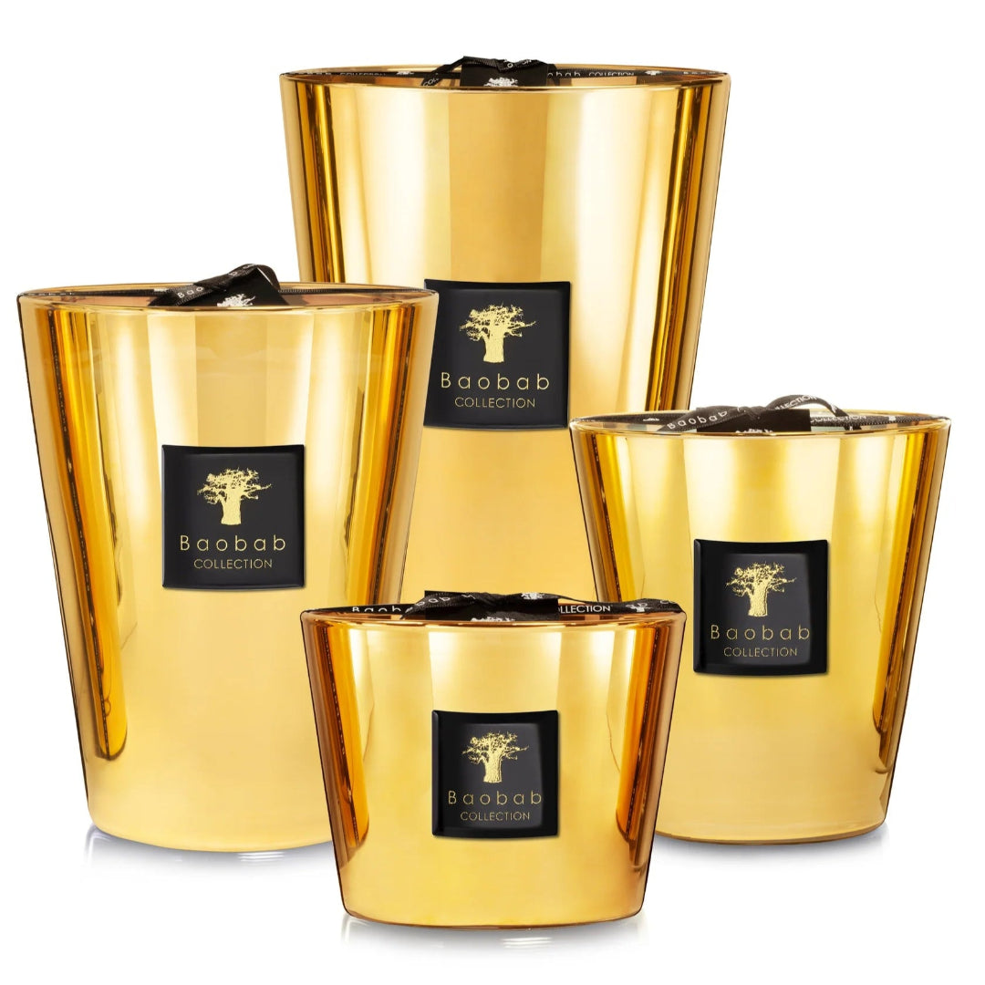 A collection of gold colored candles with glass containers, each with a label reading 'Baobab'.