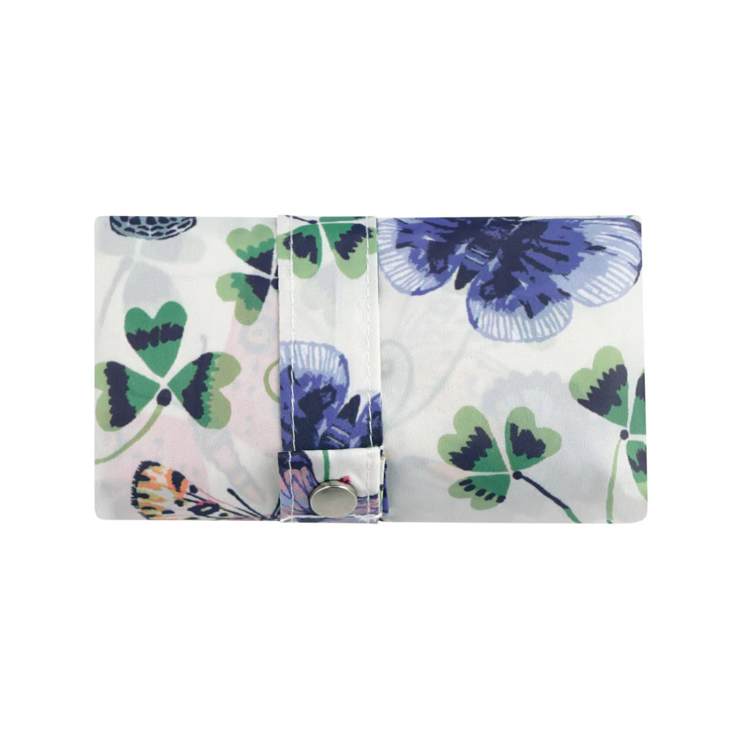 Folded fabric with butterfly and clover pattern on a white background