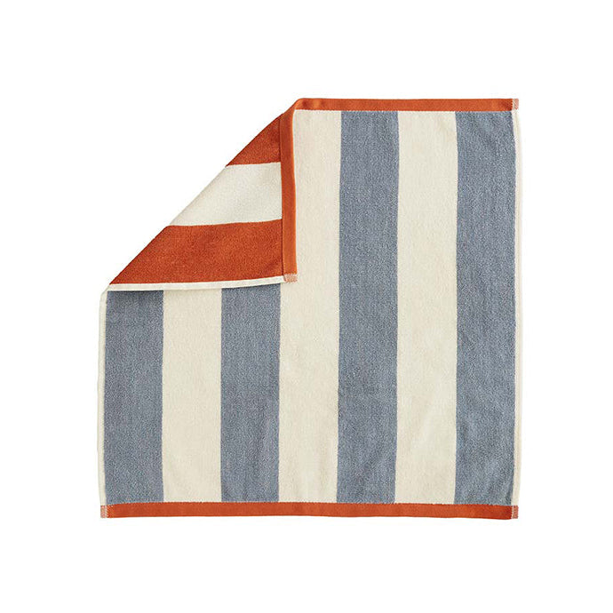 A folded striped tea towel with orange and blue colors on a white background.