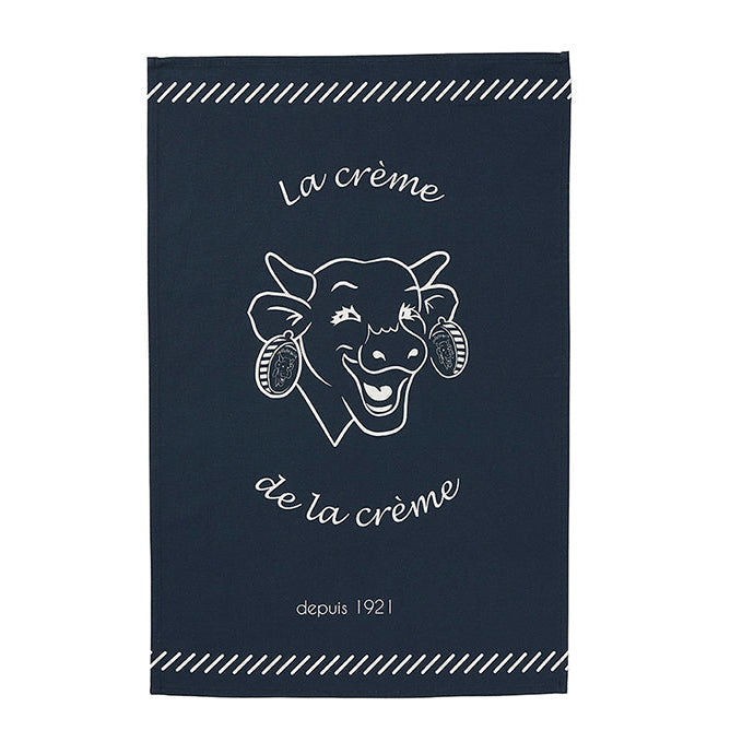 A dark blue cotton tea towel with 'La crème de la crème' printed on it and the logo of La Vache Qui Rit.