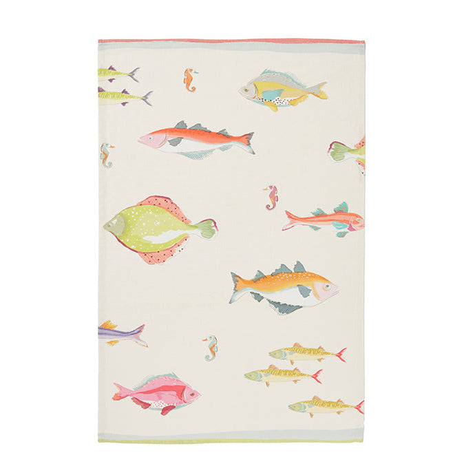 A 100% cotton tea towel with a multicolored fish pattern on a white background.