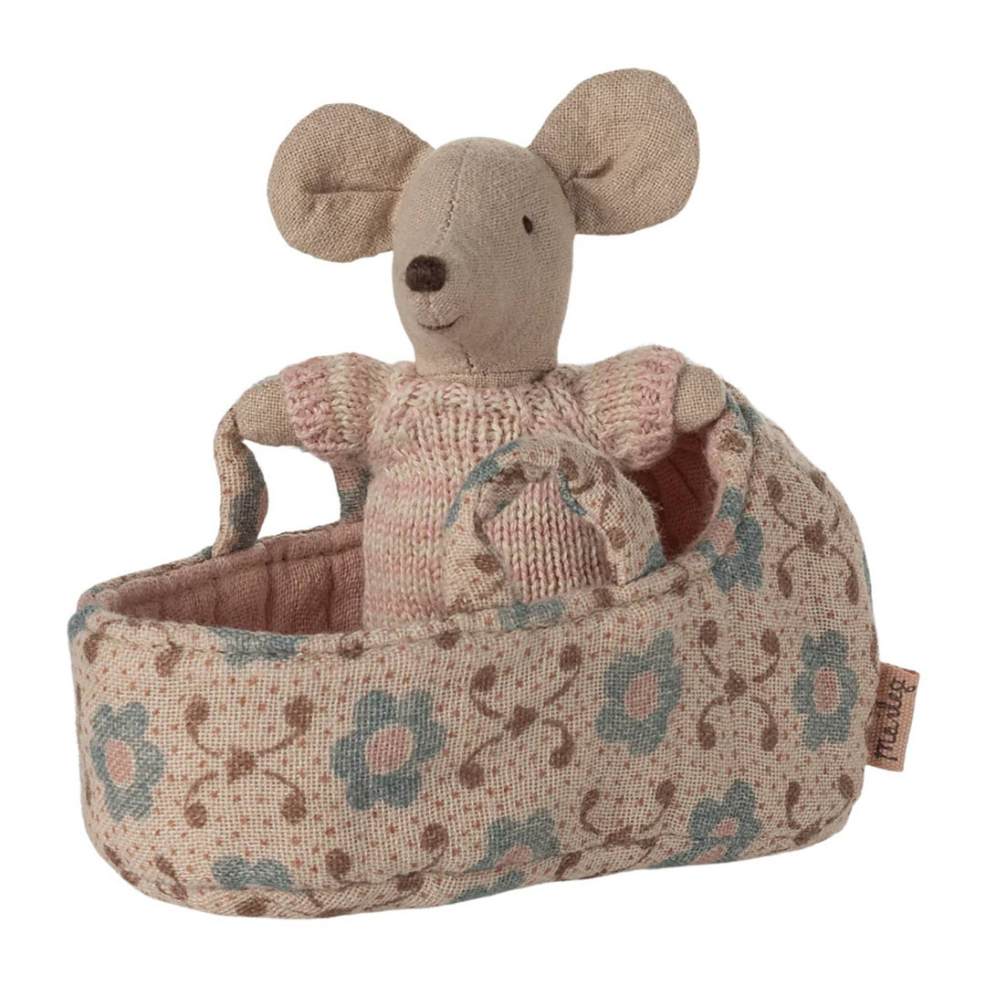 Stuffed mouse toy in a floral-patterned basket on a white background
