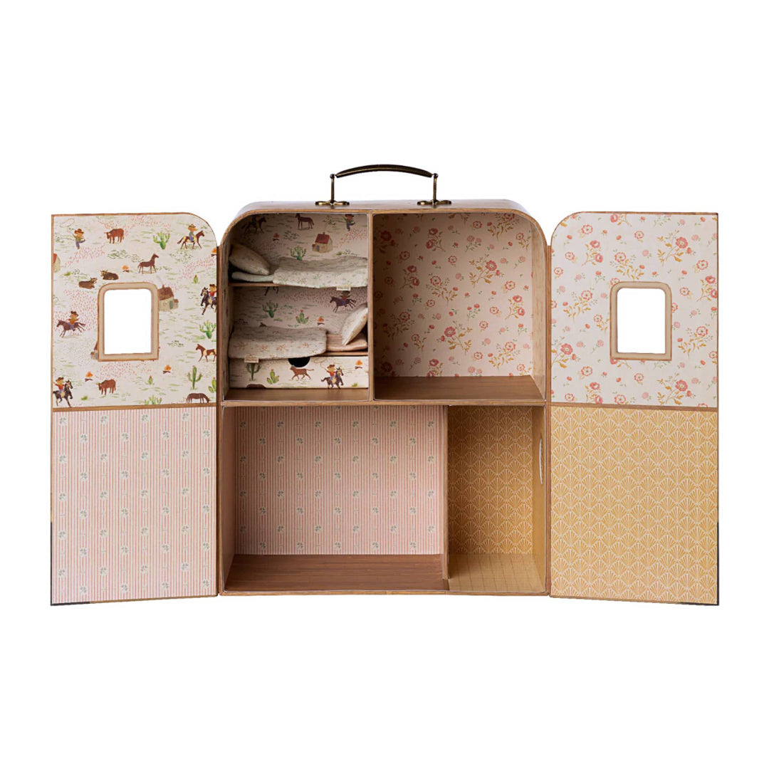Open toy suitcase with patterned interior and compartments on a white background