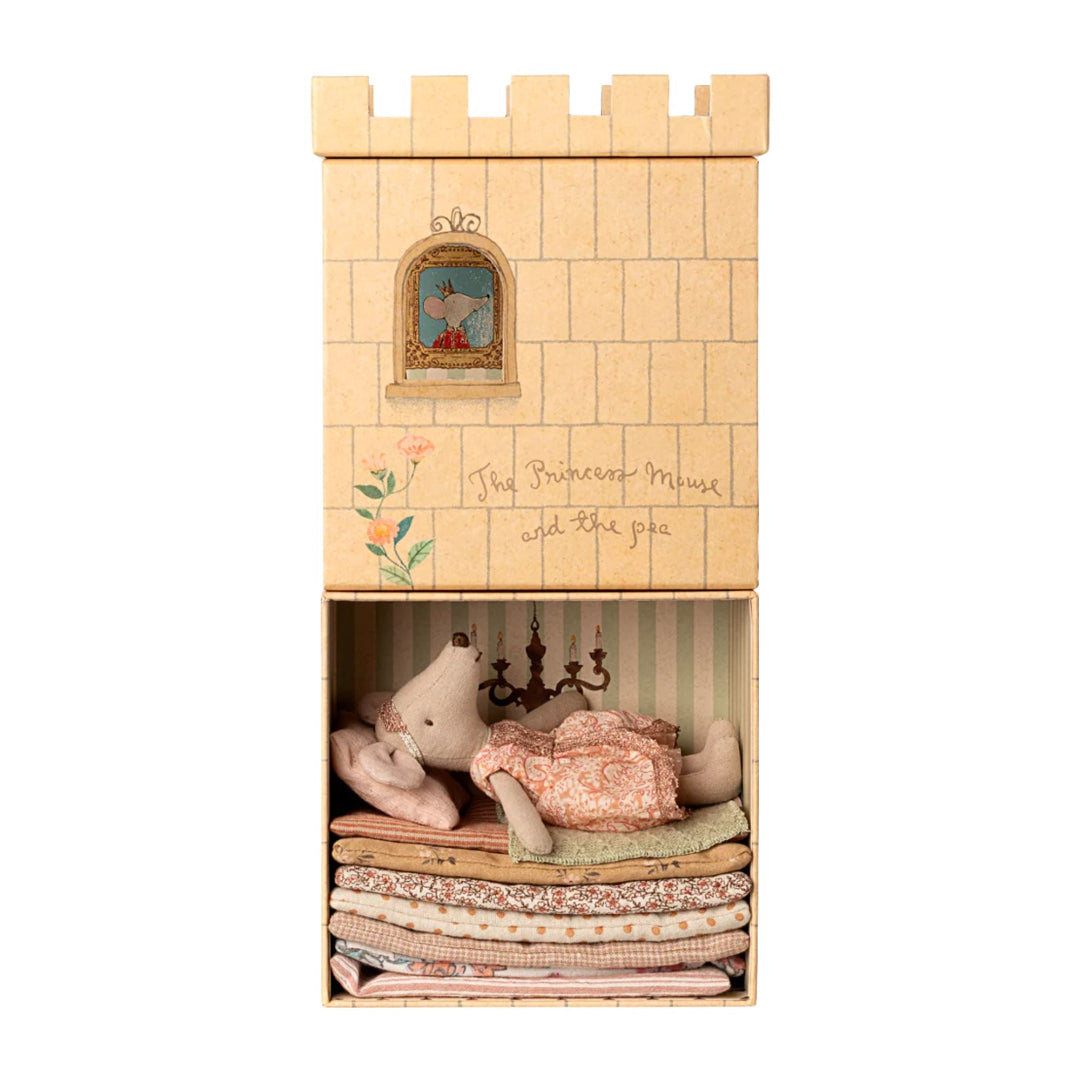 Cardboard castle toy with princess mouse inside on a white background