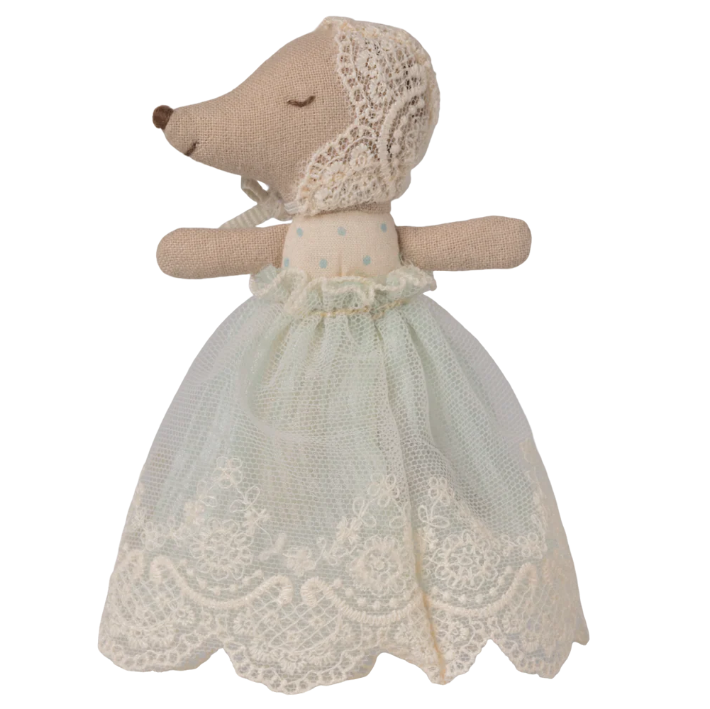 Stuffed animal toy with a lace dress on a white background