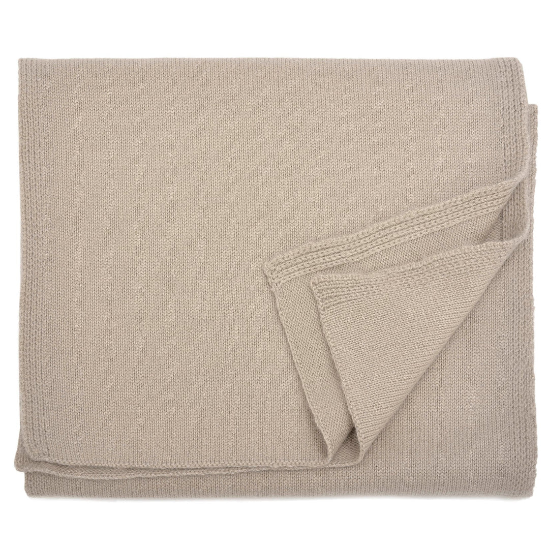 A beige cashmere scarf draped elegantly with a focus on its texture.