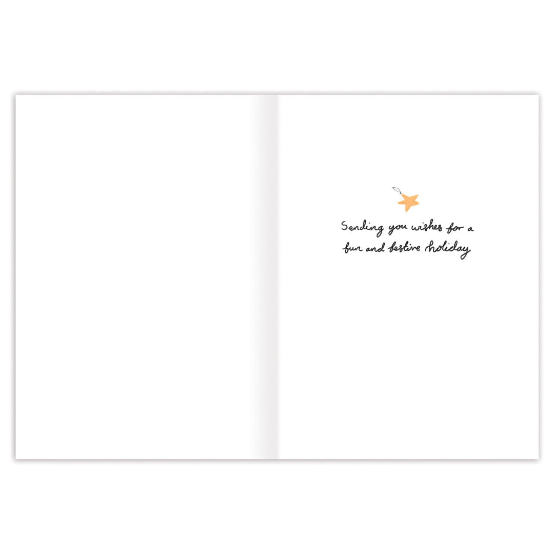 A greeting card shown open, with most of the white cardstock on the left and a small printed message on the right. The message reads, 'Sending you wishes for a fun and pleasant holiday' in black script, with a tiny star illustration above it.