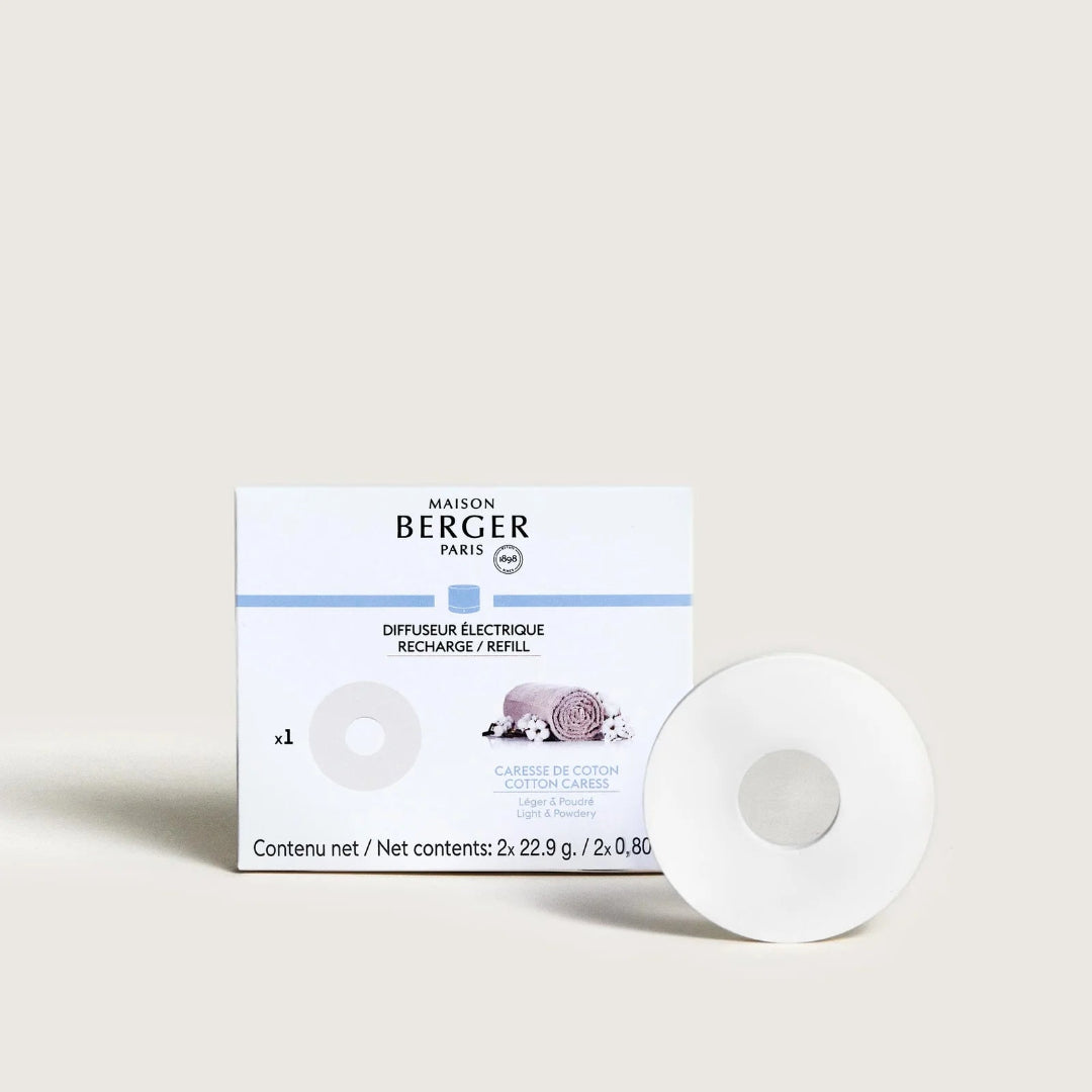 A white circular cotton caress cartridge sits in front of its white and light blue Maison Berger Paris packaging box