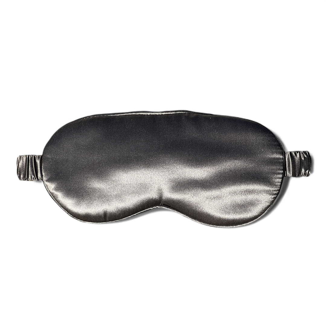 A dark grey premium organic silk sleep mask with adjustable straps.