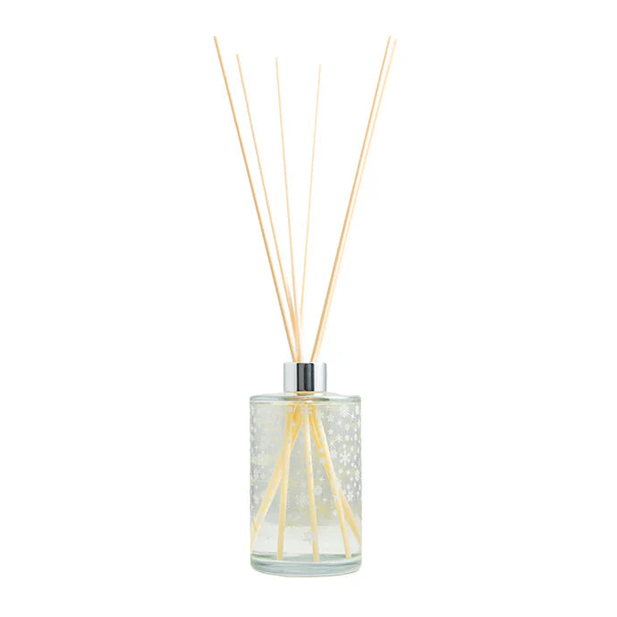 Glass diffuser bottle with wooden sticks on a white background