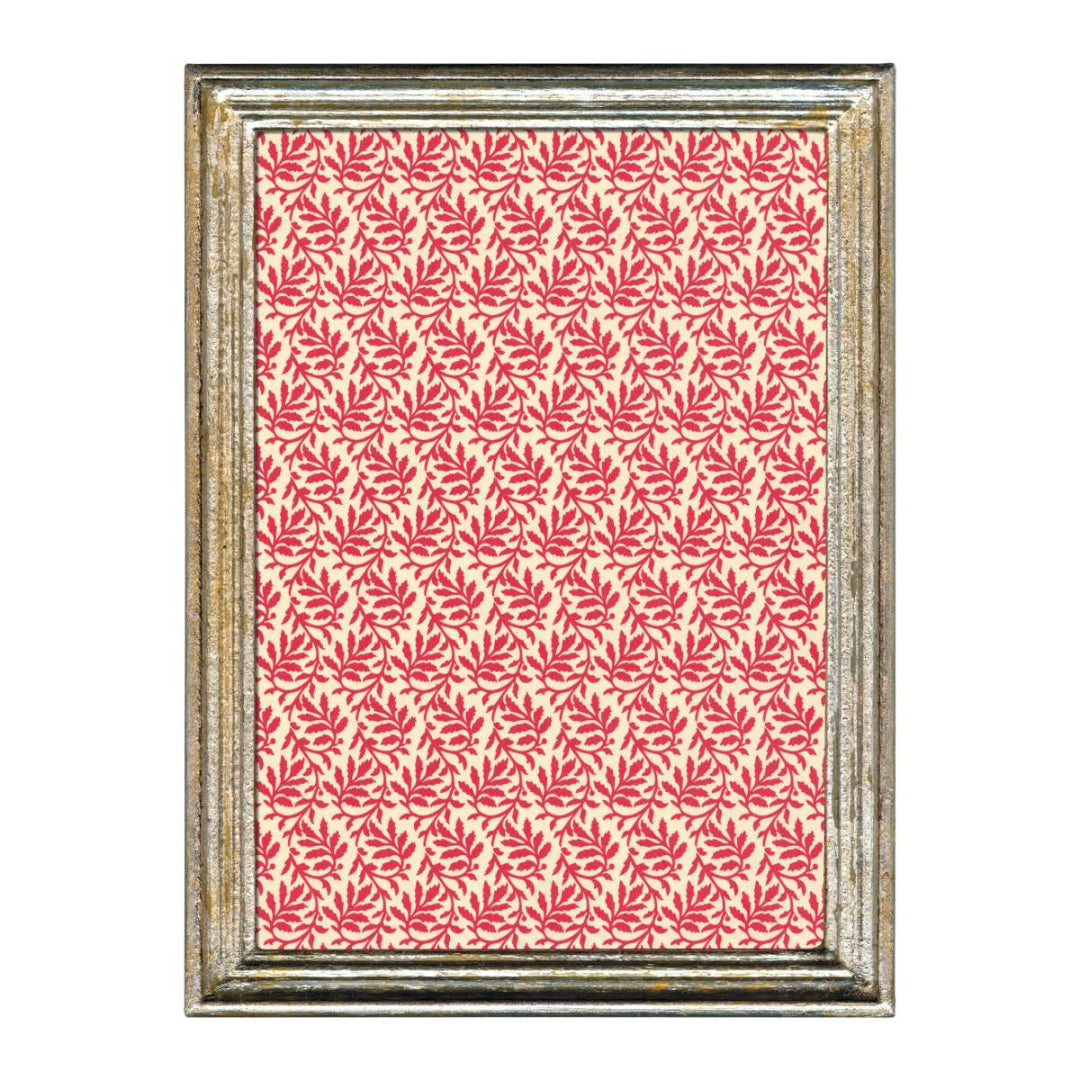 Framed artwork with a red leaf pattern on a white background