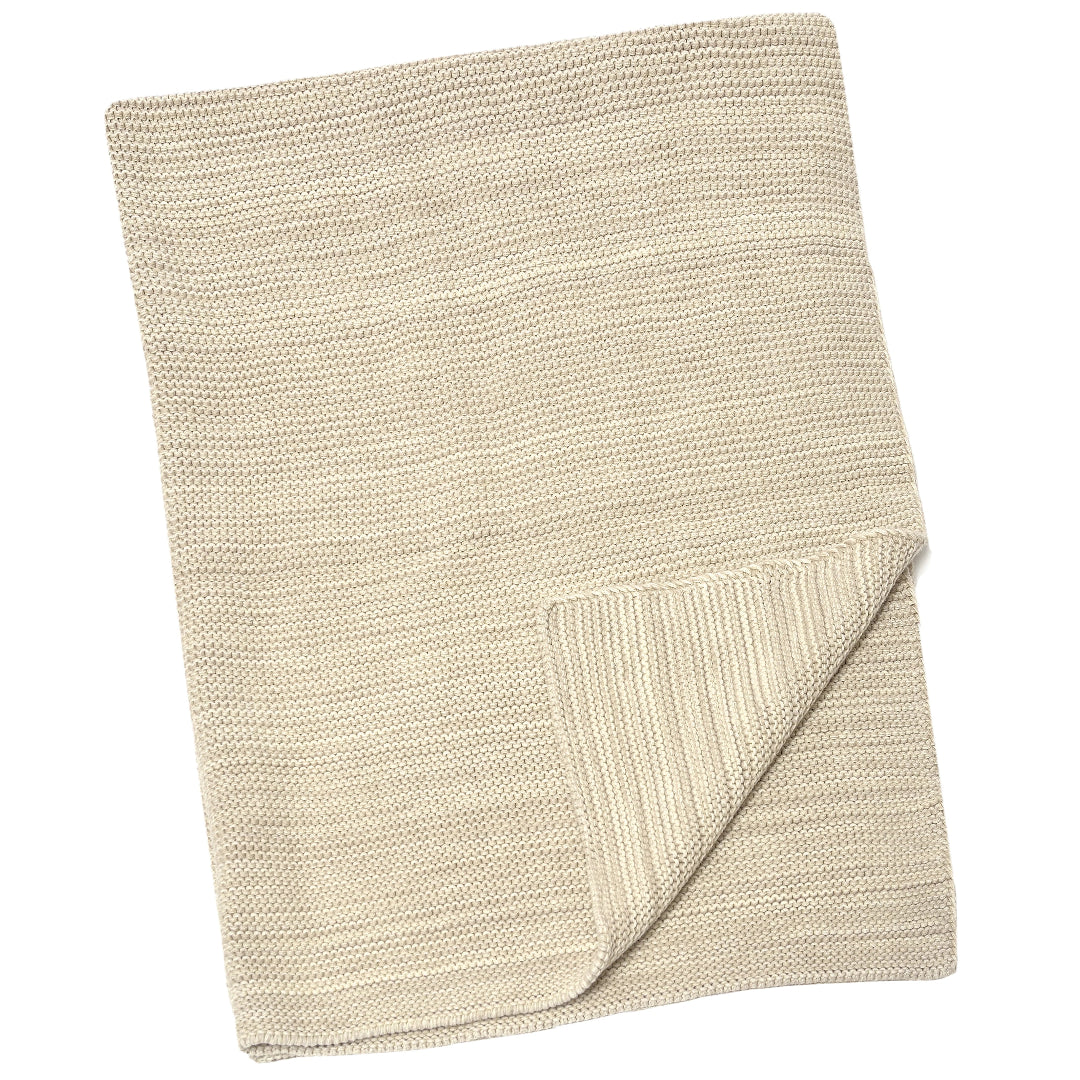 A pale whisper baby blanket with a marled-knit texture, displayed in a folded manner on a neutral background.