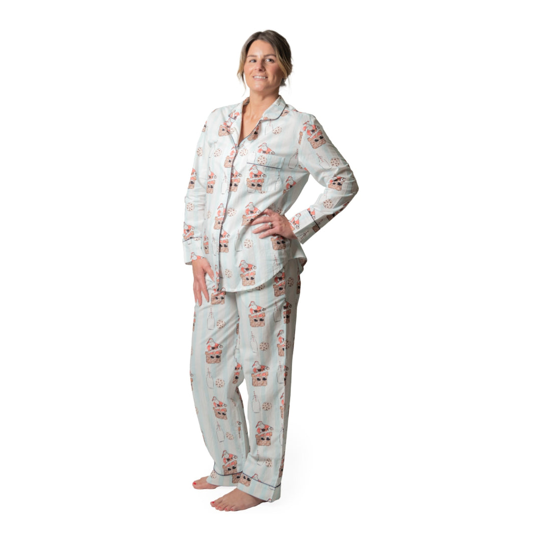 Woman wearing a pajama set with a santa pattern on a white background