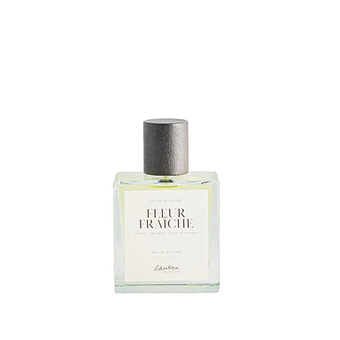 A clear glass bottle of Lothantique Eau de Parfum Fresh Blossom with a label that reads 'Fleur Fraîche' and the brand name 'Lothantique'.